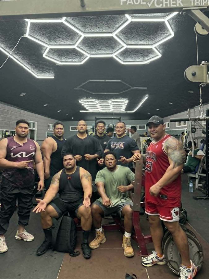 Group of members posing on the gym floor